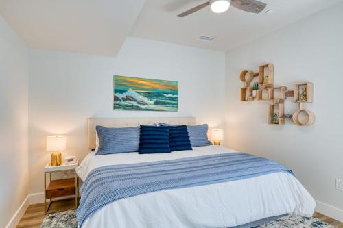 a bedroom with a large bed with blue pillows at Cypress Penthouse Traverse City Condo in Traverse City