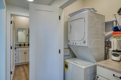 a kitchen with a washer and dryer in it at Cypress Penthouse Traverse City Condo in Traverse City