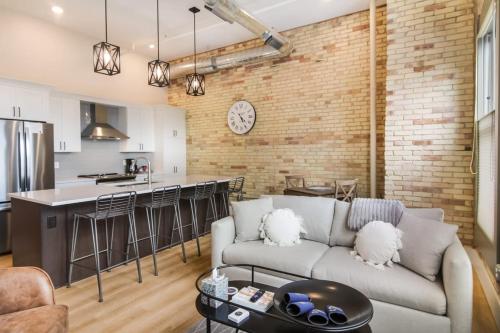 a living room with a couch and a kitchen at Golden Lofts Unit 2 Downtown Traverse City 1bd 1ba in Traverse City