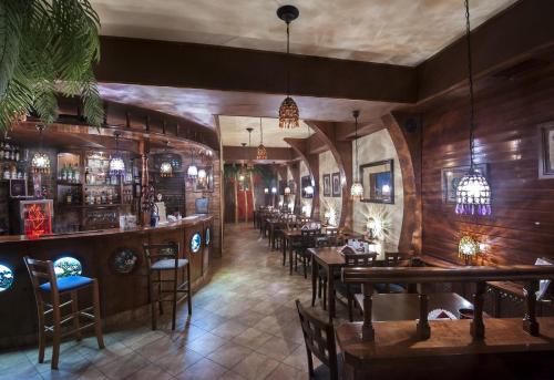 a restaurant with wooden walls and tables and a bar at Titanic in Białystok