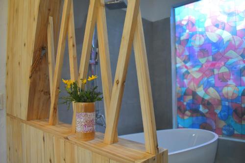 a bathroom with a wooden shelf with a tub at Tay Bac Sky Homestay in Sa Pa