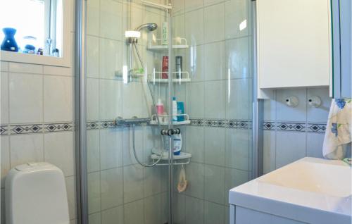 a bathroom with a shower and a toilet and a sink at Lovely Home In Utker With Wifi in Utåker
