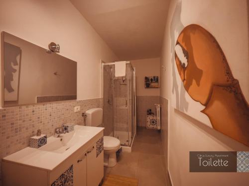 a bathroom with a sink and a toilet and a shower at CITRUS LUXURY APARTMENT - holiday apartment with up to 3 bedrooms in palermo center in Palermo