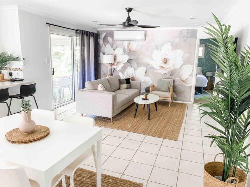 a living room with a couch and a table at Perfect Noosa Pad with Pool in Noosaville