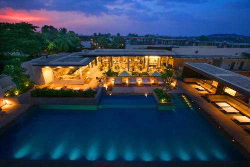 an aerial view of a building with a pool at night at BLVD Club - Near BENGALURU AIRPORT in Bangalore