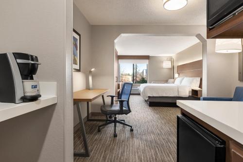 a hotel room with a bed and a desk at Holiday Inn Express Hotel & Suites Anniston/Oxford, an IHG Hotel in Oxford