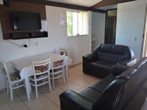 a living room with a couch and a table at OTIMO APARTAMENTO EM JACARAIPE ES ! in Serra