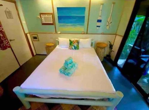 a white bed in a room with at DJs Beach Resort in Union
