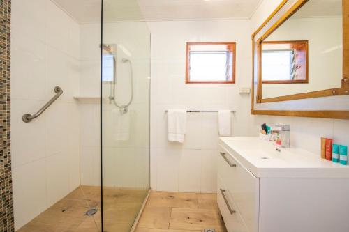 a bathroom with a shower and a sink and a mirror at Island View Apt 1 in Arcadia