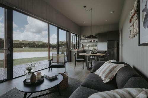 un soggiorno con divano e tavolo di Sixty6 Acres Sunshine Coast farmstay a Woombye