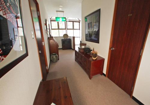 a room with a hallway with a wooden door at Gableview Forest Inn ゲーブルビュー in Nikko