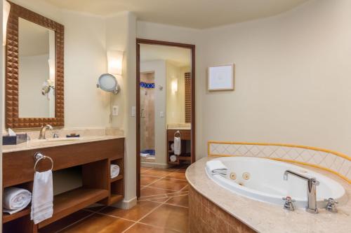 a large bathroom with a tub and a sink at The Club at Hacienda del Mar in Cabo San Lucas