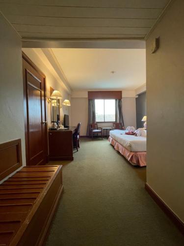 Ένα ή περισσότερα κρεβάτια σε δωμάτιο στο Songphanburi Hotel