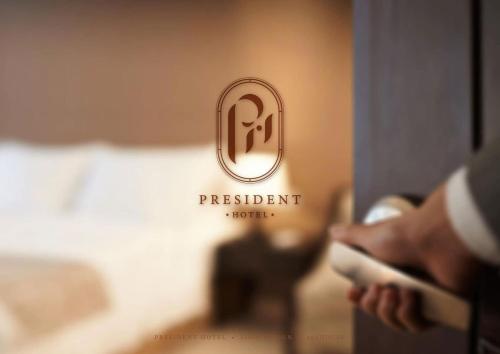 a person holding a wii remote in a hotel room at President Hotel Udonthani in Udon Thani