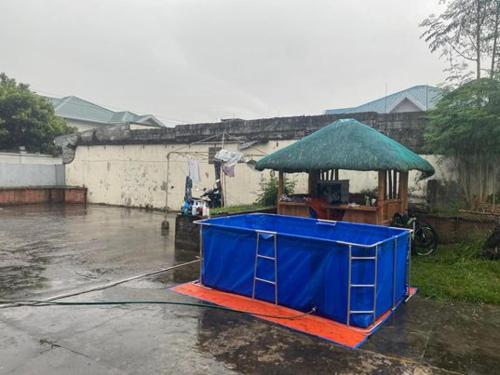 a blue cart with a green umbrella on a street at Molly's Place with kubo and parking in Angeles