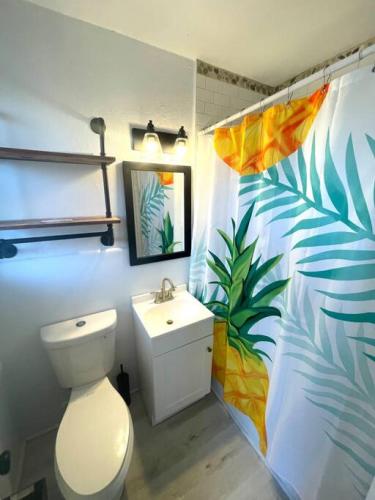 a bathroom with a toilet and a sink at Pineapple Shores Retro Motel 9 in Daytona Beach