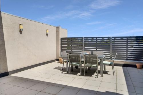 a patio with a table and chairs on a balcony at 32a Sackville St in Port Fairy