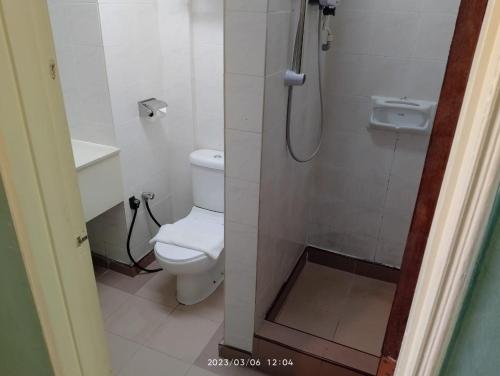 a bathroom with a toilet and a shower at Hotel Seri Malaysia Taiping in Taiping