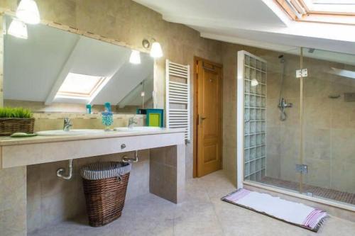 ein Bad mit einem Waschbecken und einer Dusche in der Unterkunft Villa very quiet, fantastic views, ideal for families, fun and relaxation. in São João da Ribeira
