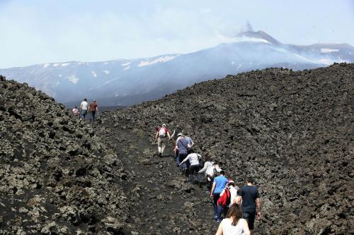 a group of people walking up a mountain at BASTIÒ PRIVATE SUITES in Catania
