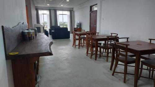 a dining room with wooden tables and chairs at Jays Guest - Rajagiriya Colombo in Rajagiriya
