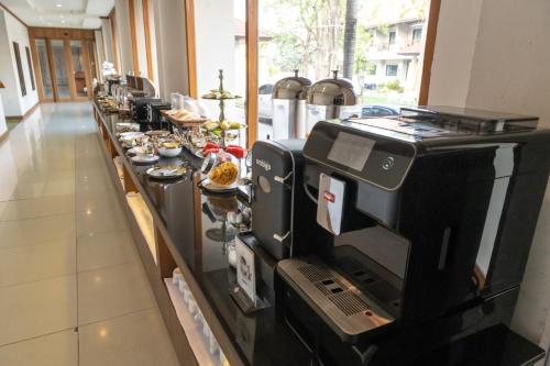 a long buffet line with food on it at President Hotel Udonthani in Udon Thani
