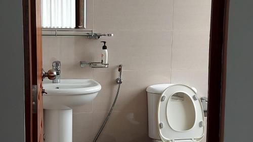 a small bathroom with a toilet and a sink at Jays Guest - Rajagiriya Colombo in Rajagiriya