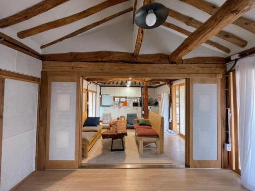 a living room with a ceiling with wooden beams at Hanok Stay - JukRokJungSa in Gurye