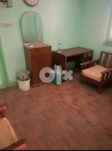 a room with a toilet and a table and a chair at المحله الكبرى in Al Mahallah Al Kubra