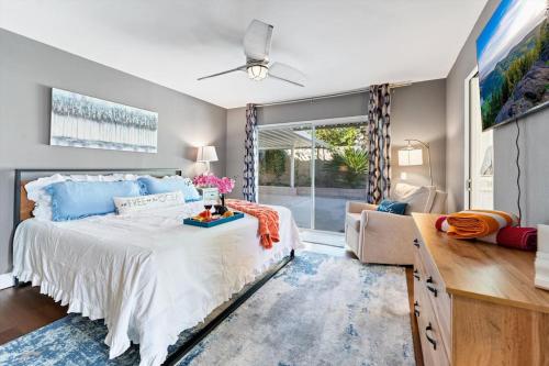 a bedroom with a large bed and a large window at Seabreeze-Modern Home w Outdoor Living&Near Beach in Huntington Beach