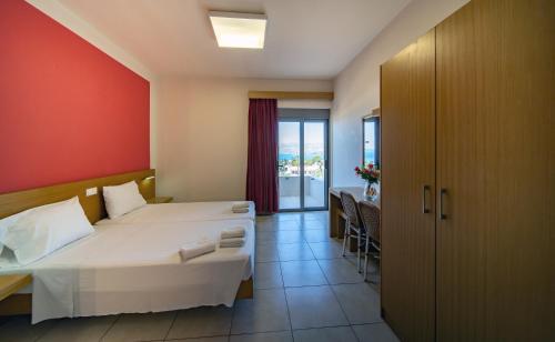 a hotel room with a bed and a balcony at Lia Studios in Pefki Rhodes