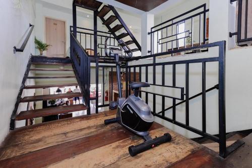 a room with a iron staircase with a vacuum at RedDoorz near Alun Alun Madiun in Madiun