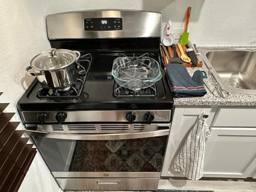 a stove with a pot on top of it in a kitchen at Lackland-area new cozy 2BR home in San Antonio