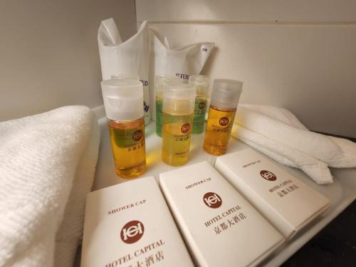 three glasses of beer sitting on a table with towels at Hotel Capital Kota Kinabalu in Kota Kinabalu