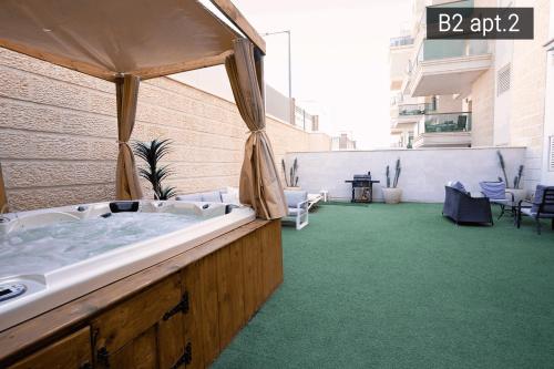 a large bath tub sitting in the middle of a building at YalaRent Palmore Resort apartments in Eilat