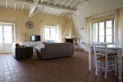 a living room with a couch and a table at Agriturismo Piani Della Marina in Montalto di Castro