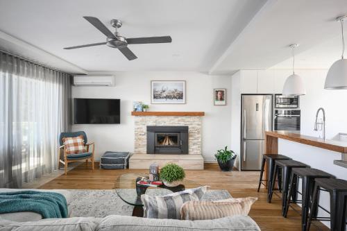 a living room with a couch and a fireplace at 13 Mountbatten in Bright