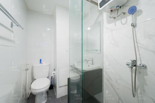 a bathroom with a toilet and a glass shower at RedLiving Apartemen Parahyangan Residence - Anton Rooms in Bandung