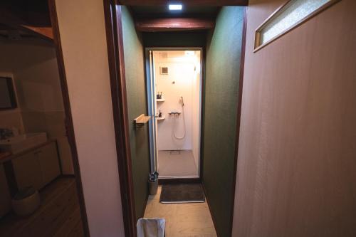 a bathroom with a shower and a toilet in a room at Guest House Himawari - Vacation STAY 31402 in Mine