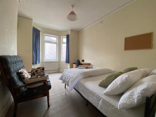 a bedroom with a bed and a chair and a window at Nice Living Serviced Accommodations 5 in Coventry