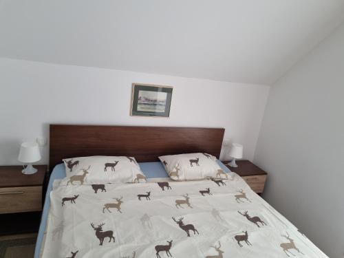 a bedroom with a bed with a blanket with horses on it at Holiday Mountain House Rupicapra in Kostel