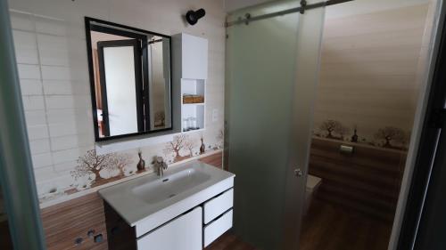La salle de bains est pourvue d'un lavabo et d'un miroir. dans l'établissement HỒNG BIN RESORT, à Duong Dong