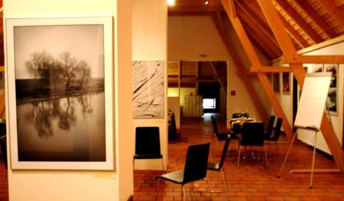 a living room with a table and chairs at Sopron Monastery Hotel in Sopron