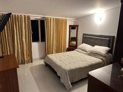 a small bedroom with a bed and a window at Apartamento Acogedor Samuel y Bella in Bogotá