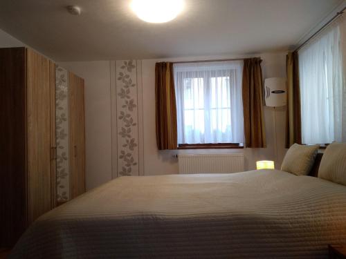 a bedroom with a large bed and a window at Ferienwohnung Königstein in Bad Schandau