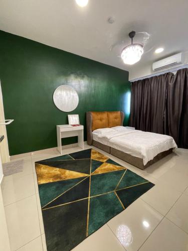 a bedroom with a bed and a green wall at Premium Service Appartment in Seri Kembangan