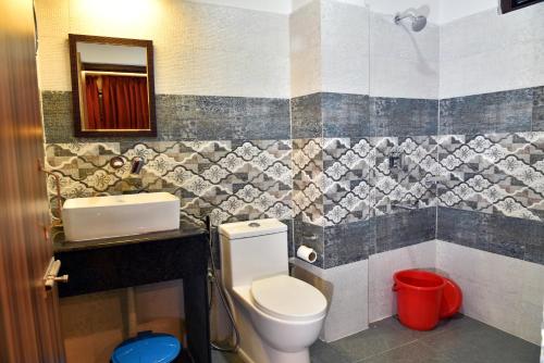 a bathroom with a toilet and a sink at Rufina Palm Bliss in Pelling