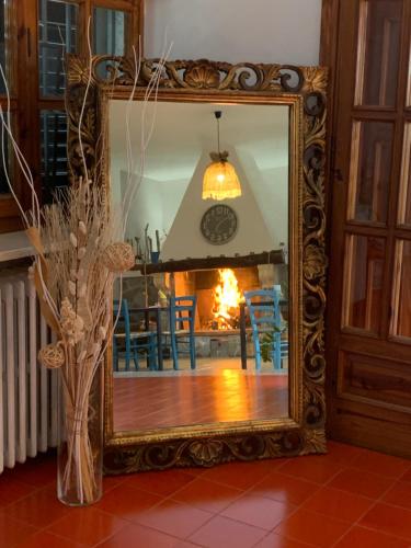 a mirror reflection of a dining room with a fireplace at Villa Anna GuestHouse in Brindisi