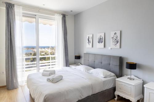 a bedroom with a large bed with a large window at The View Feb 2023 last renovation in Athens
