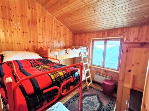 a bedroom with a bed in a wooden cabin at Maison Elios 2 CIR-TORGNON-0005 in Torgnon